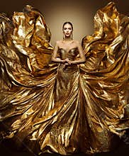 Gold woman flying dress, fashion model in waving art golden gown