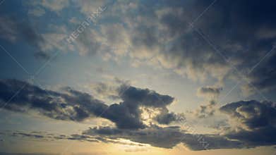 Timelapse of clouds in evening with blue and yellowed vintage effect. Souvenir sensation in soft appearance, cool tones.