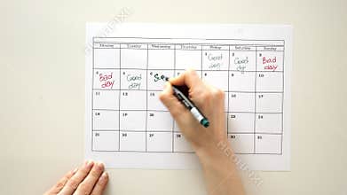 Sign the day in the calendar with a pen, draw a good bad day