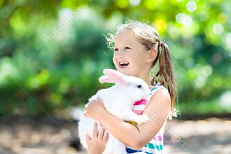 Child with rabbit. Easter bunny. Kids and pets.