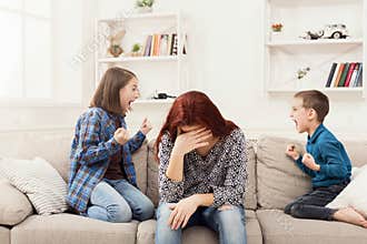 Kids having quarrel over tired mother