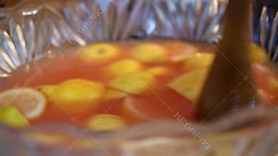 Mixing Lemons in punch bowl to make pink lemonade or kool-aid ALT