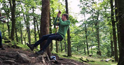 Teenager Having fun on a Rope Swing