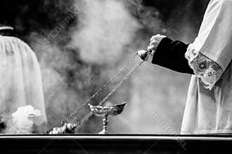 altar boy of the catholic church with thurible in his hand during a celebration