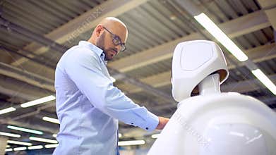 Cybernetic system today. Modern Robotic Technologies. Humanoid autonomous robot. a man using his touch screen. High tech