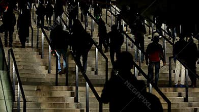 Silhouettes of people walking upstairs, crowd entering sports stadium, tourists