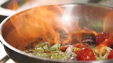 Cook fires up oil in a pan