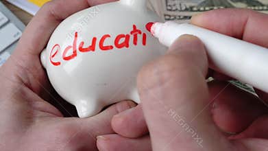 Money for college. Man draws a word Education