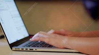 Woman`s Hands programming on Laptop CLOSE UP
