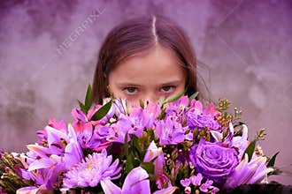 Teenage girl with large bunch of colorful flowers