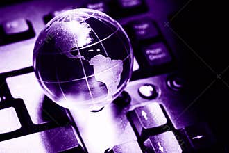 World transparent globe earth on computer keyboard. Global communications business concept. Ultraviolet colored Image. Color of th