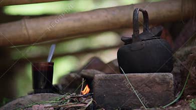 Old kettle on bonfire