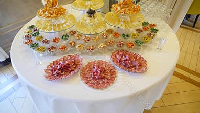 Decorated catering banquet table with chips, nuts and different food