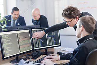 Startup business problem solving. Software developers working on desktop computer.