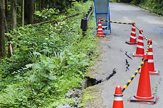 Damaged road with warning signs