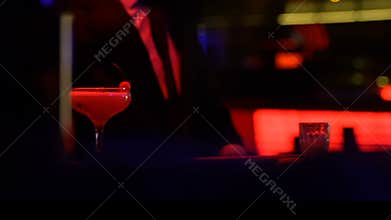 Man in suit ordering alcohol drink in pub, relaxing after work, night lifestyle