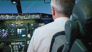 Captain is controls the airplane, rear view.