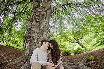 Couple talking under a big tree