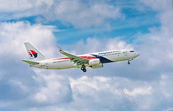 Passenger aircraft Boeing 737 of Malaysia Airlines fly in sky prepare to landing at Tan Son Nhat International Airport