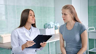 Female doctor in white lab coat discussing symptoms with sick girl complaints making diagnosis