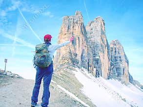 Backpacker on trip aound Tre Cime di Lavaredo in sunny April morning.