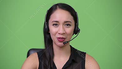 Young beautiful Asian businesswoman as call center representative