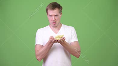 Young handsome man smelling poo