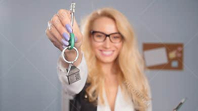 Concept of sale and lease of real estate. Realtor is giving the keys to an apartment to clients