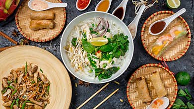 Assorted asian dinner, vietnamese food. Pho ga, pho bo, noodles, spring rolls