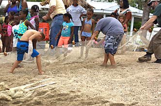 Little fishermen team with net trying caught fish
