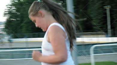 Little fat girl runs in the stadium