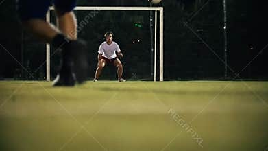 Player kicked the ball, aiming at the goal, but the goalkeeper hit the ball