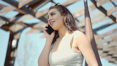 Beautiful young woman talking by the cellphone