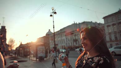 Love and soap bubbles blow by married couple.