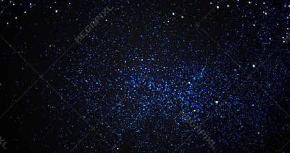 Christmas blue gradient sparkle glitter explosion dust particles background with bokeh flowing movement falling down in slow