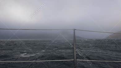 Sailing ship swinging on stormy sea waves view from board. Cruise ship in storm