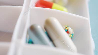 A doctor spreads out pills and medication for the week using in the daily pill box.