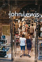 People entering John Lewis shop inside St. Pancras station, London, UK.