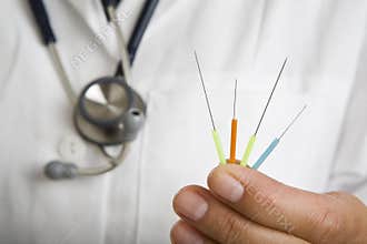 Doctor holding acupuncture needles