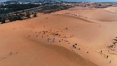 AERIAL. Point of interest drone shot of people having attractions in the Red Sand Dunes of Mui Ne, Vietnam