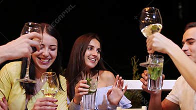 Group of friends are clink glasses with drinks at cafe.