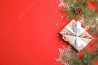 Christmas composition with gift box and festive decor on color background