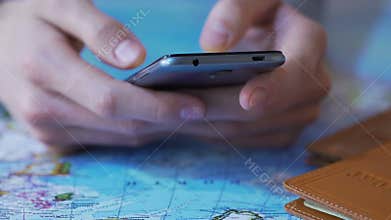 Closeup male hands holding smartphone, booking tickets and hotel in tourists app