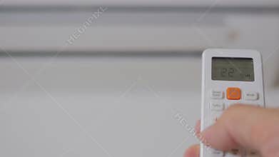 The hand with the remote control includes a domestic conditioner