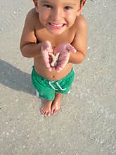 Boy with sea shell