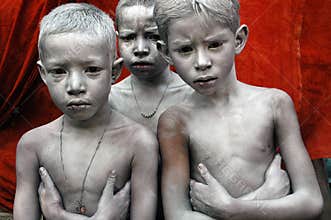 THREE BOY'S FACE SMEARED WITH COLOUR