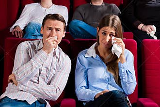 Couple and other people in cinema