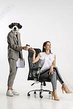 Contemporary art collage of two female employees, personal assistant with dog head giving cup of coffee to her boss