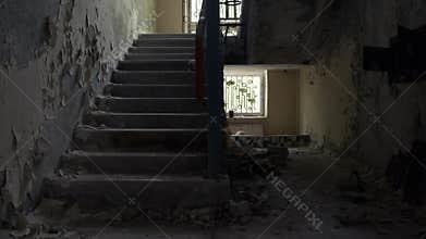 Abandoned creepy staircase in ghost town Pripyat. Camera slow motion dolly shot