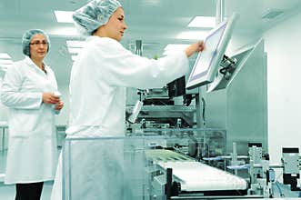 Working people at production line